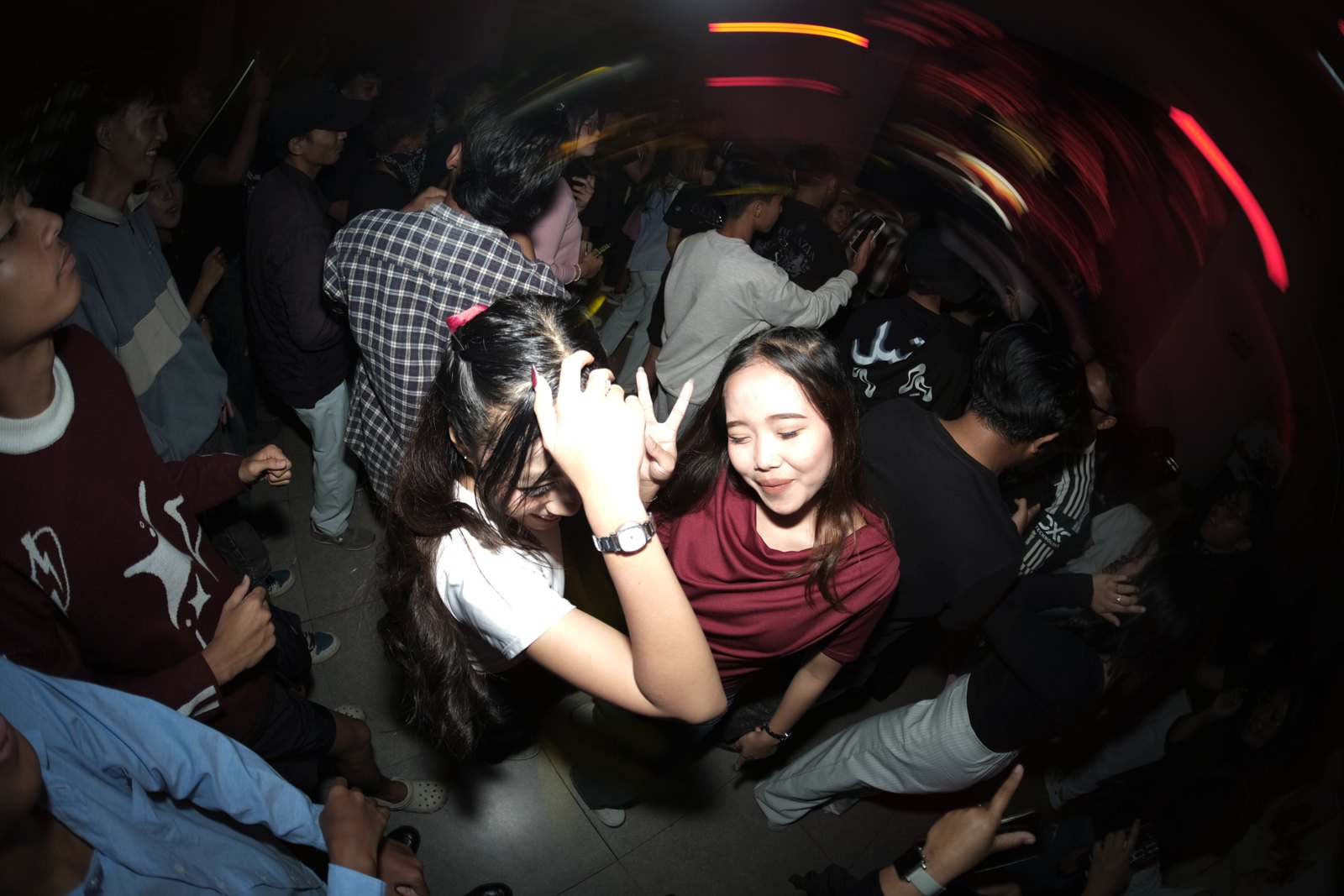 Dua pengunjung Liveverse menari di antara penonton.